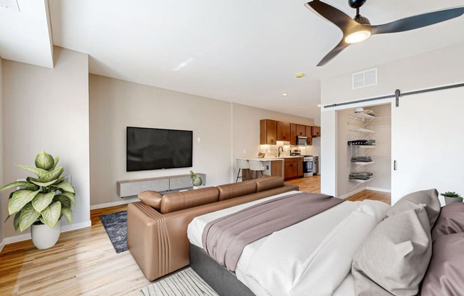 a bedroom with a couch and a tv