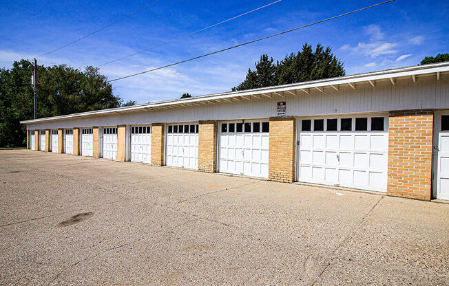 a row of garages with a blue sky in the background