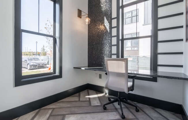a home office with a desk and a window
