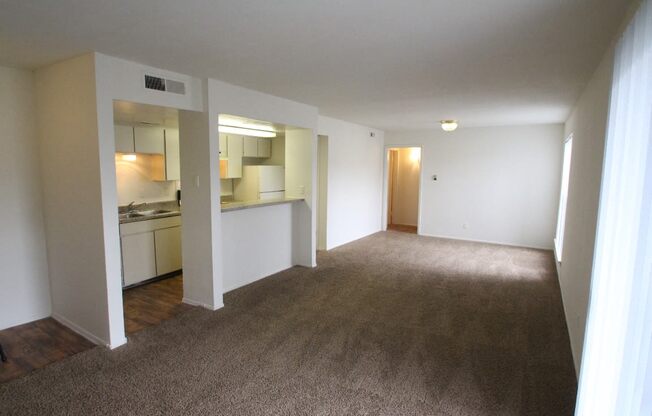 This is a photo of the living room/kitchen area of the 1007 square foot 2 bedroom apartment at The Biltmore Apartments in Dallas, TX.