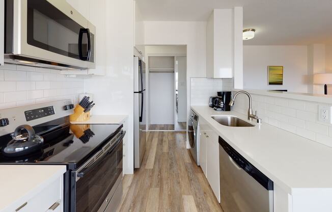 a kitchen with a stove top oven next to a sink