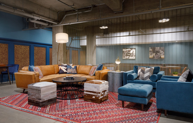 a living room with couches and chairs and a rug