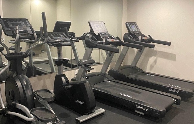 a gym with treadmills and other exercise equipment in a building