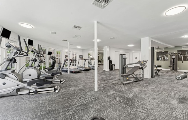 A gym with a variety of exercise equipment.