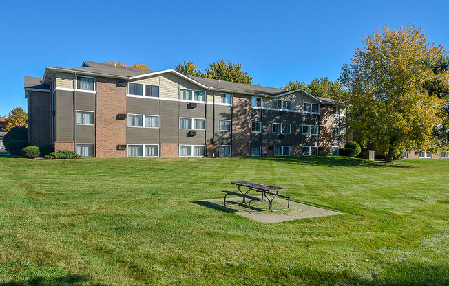 Exterior of a Timberland at Crestbuck Apartment Building Overlooking the Green Grass and Picnic Area