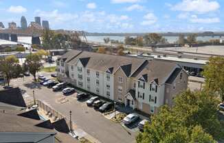 an aerial view of an apartment complex with a river in the background