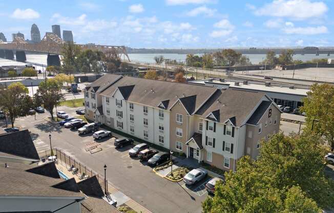 an aerial view of an apartment complex with a river in the background