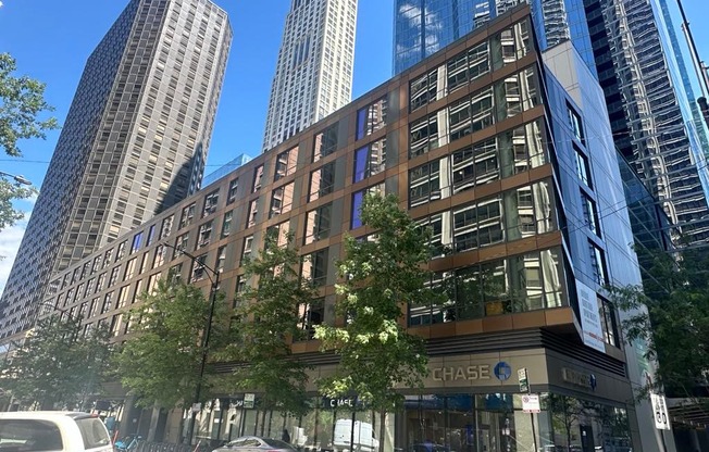a building on a city street with tall skyscrapers