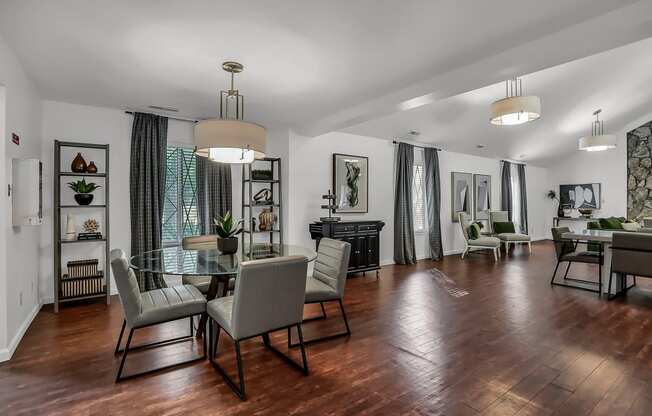 a living room and dining room with a table and chairs