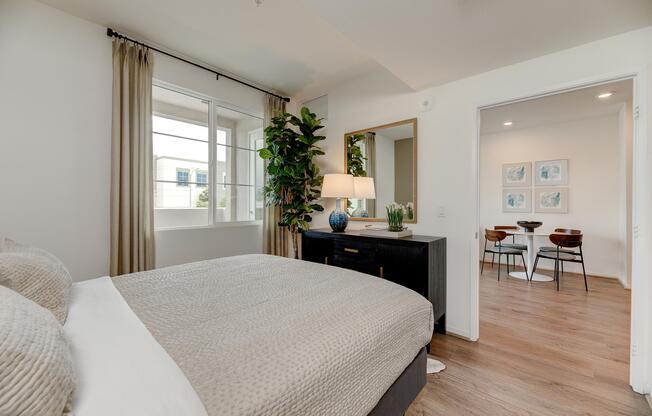 a living room filled with furniture and a bed in a bedroom