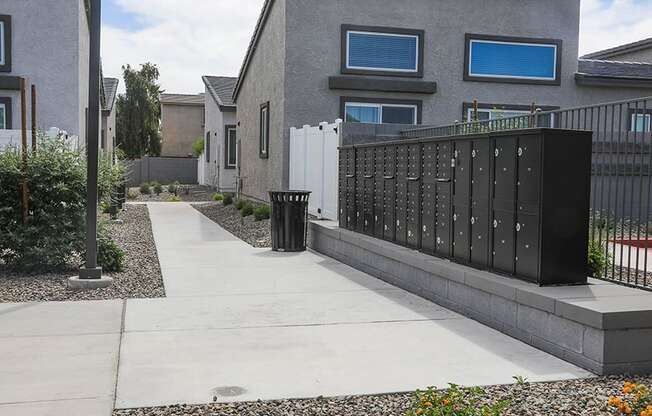 a fence and a trash can in front of a house