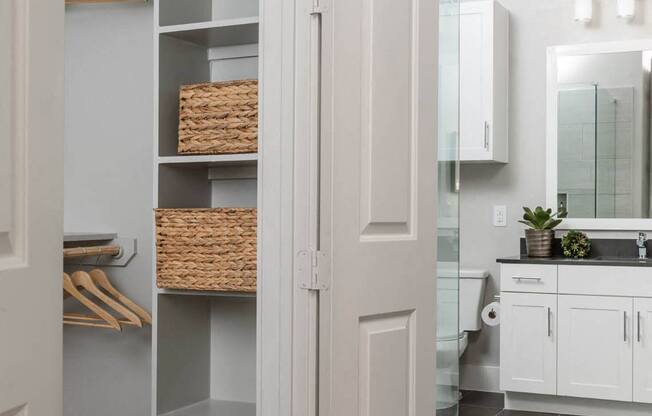 a bathroom and closet with shelving at Tinsley on the Park apartments