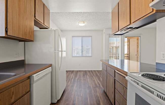 A kitchen with wooden cabinets and white appliances.