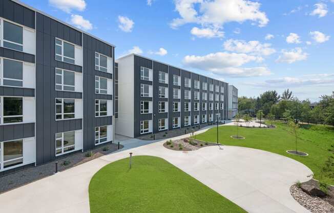 an exterior view of a building with green grass and a sidewalk at Ironside Apartments, Spokane , WA
