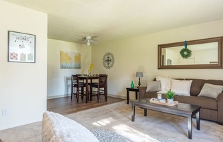 The Springs living room with carpet flooring and ceiling fans