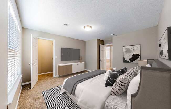 A bedroom with a bed, a television, and a window with blinds.