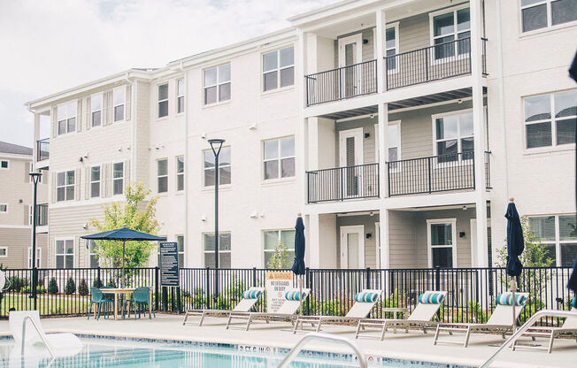 a swimming pool in front of an apartment building
