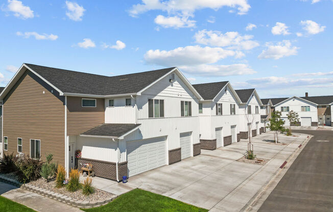 a row of white and brown houses on a street