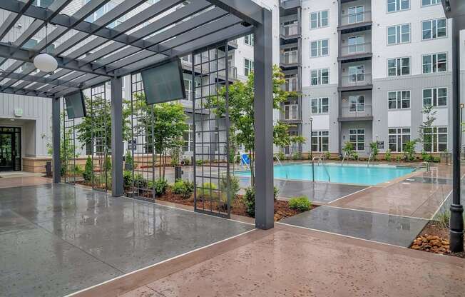 an empty pool in front of an apartment building