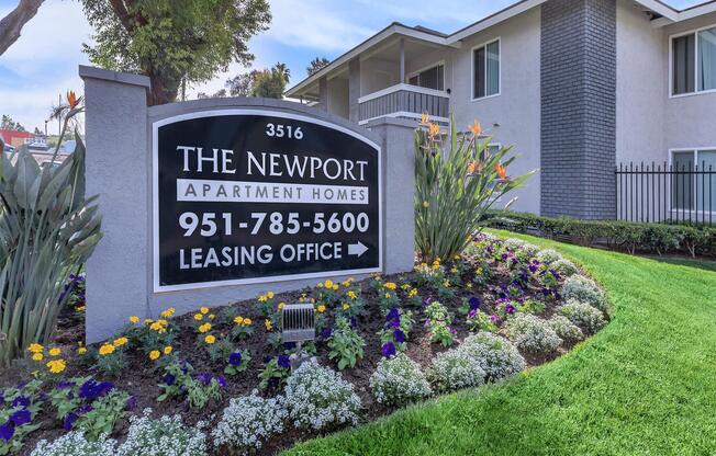 a sign above a flower garden