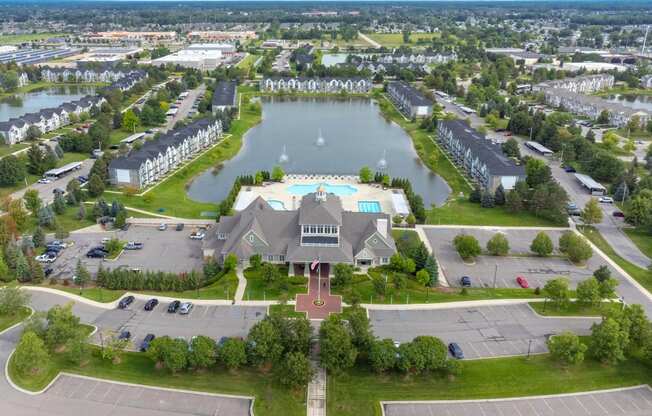 a mansion with a lake in the middle of it