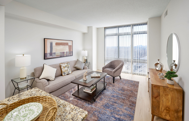 The Ellington living room is transformed with modern vinyl plank wood-style flooring and an updated lighting package. The space feels bright and airy, controlled by a new Google NEST thermostat for effortless climate management.
