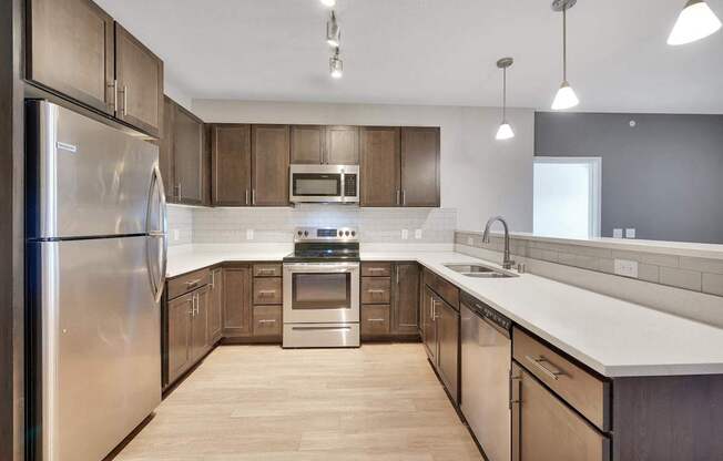 A modern kitchen with wooden cabinets and stainless steel appliances.