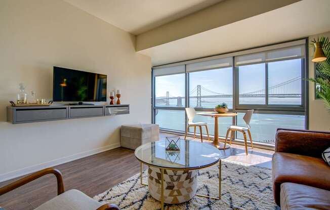 A living room with a large window overlooking the Golden Gate Bridge.