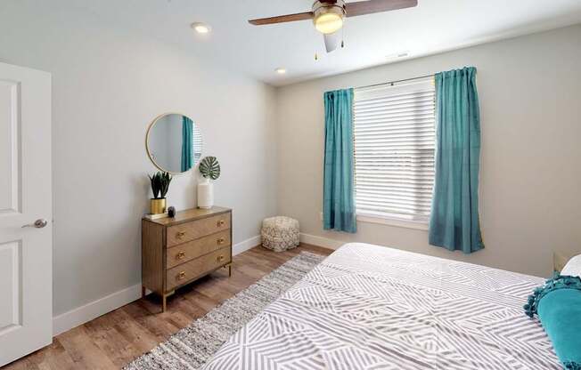 a bedroom with a bed and a ceiling fan at Echo Park at Perry Crossing Apartments, Indiana