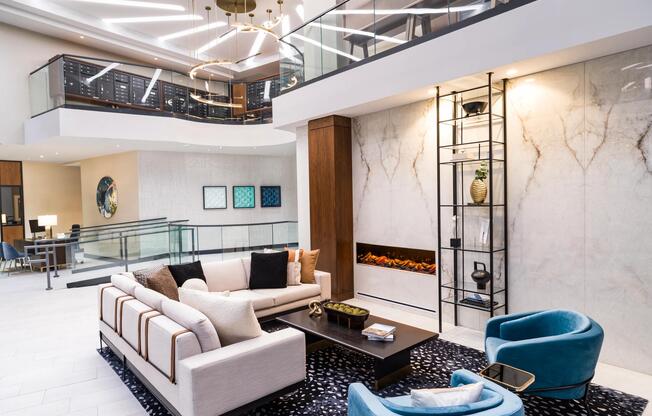A refined leasing lobby lounge at Modera McGavock, where layered lighting and modern design welcome you home.