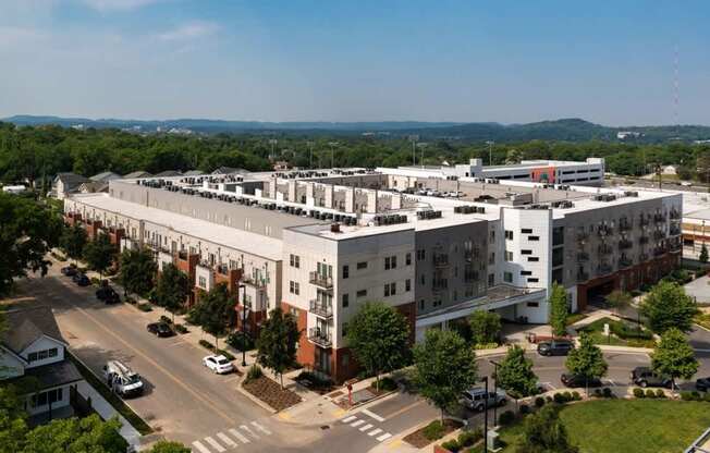A large white building with a parking lot in front of it.