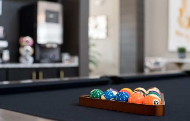 a tray of colorful easter eggs on a pool table