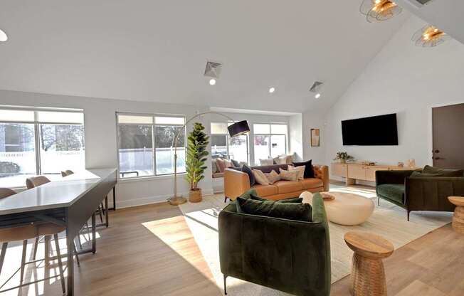 A living room with a green couch and a wooden floor.