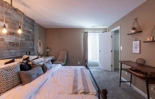 This is a photo of the bedroom with barb wood wall in the upgraded 650 square foot, 1 bedroom, 1 bath model apartment at Deer Hill Apartments in Cincinnati, Ohio.