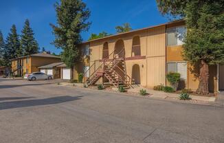 a house that has a sign on the side of a road