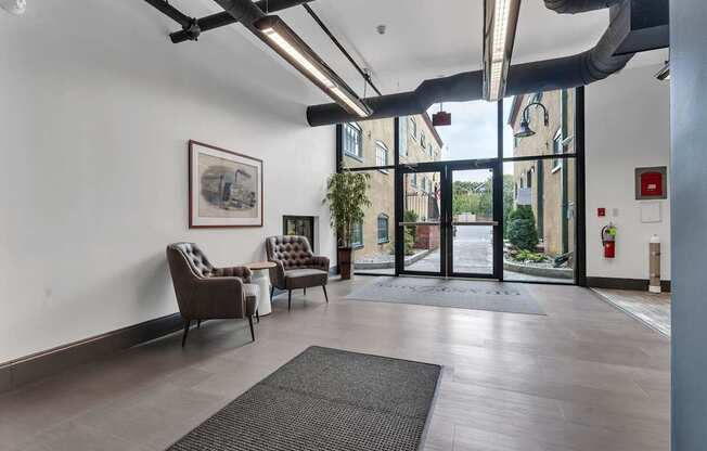 A room with a grey floor and a fire extinguisher on the wall.
