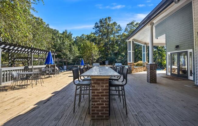 Large deck with a table and chairs on it at University Ridge Apartments, Durham, NC, 27707