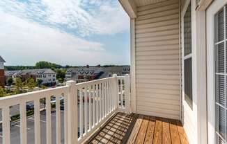 a balcony with a view of the city and the horizon in the distance