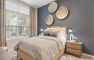 a bedroom with gray walls and a bed with a wooden headboard at The Griffin Royal Oak, Royal Oak, 48067