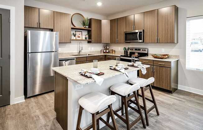 A kitchen with a table and chairs in front of it.