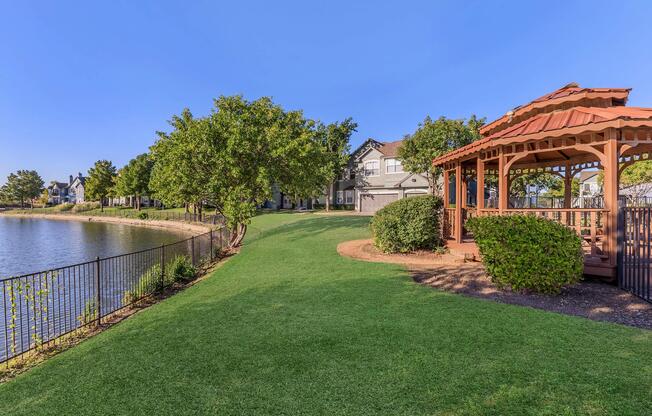 a large brick building with green grass in front of a house