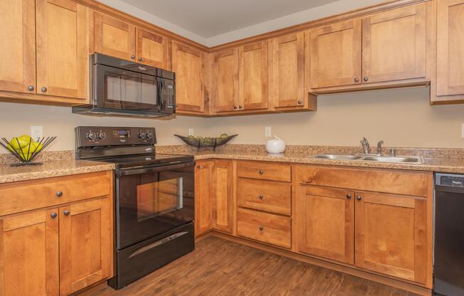 a kitchen with stainless steel appliances and wooden cabinets