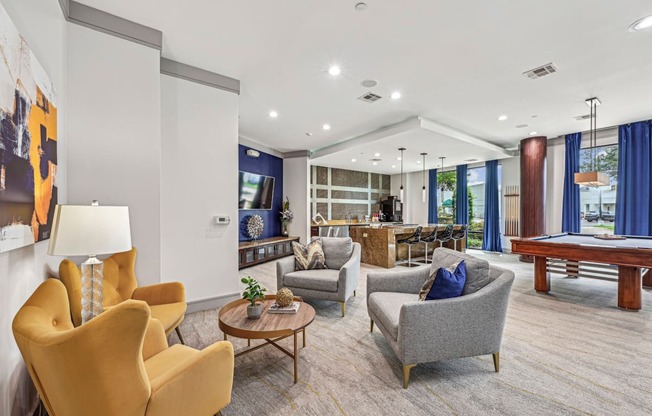 Stylish resident lounge with ample seating and contemporary art at Allusion at West University apartments in Houston, TX