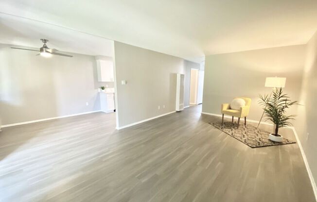 a living room with a hard wood floor and white walls at BLVD Apartments LLC, Tarzana