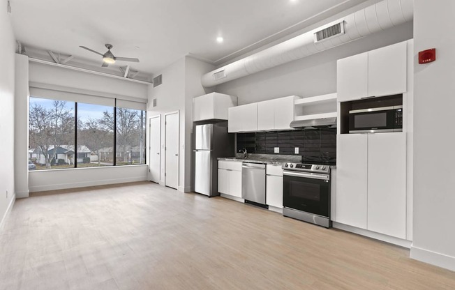 A spacious kitchen with white cabinets and stainless steel appliances. at Brickside Heights, Millcreek, 84106