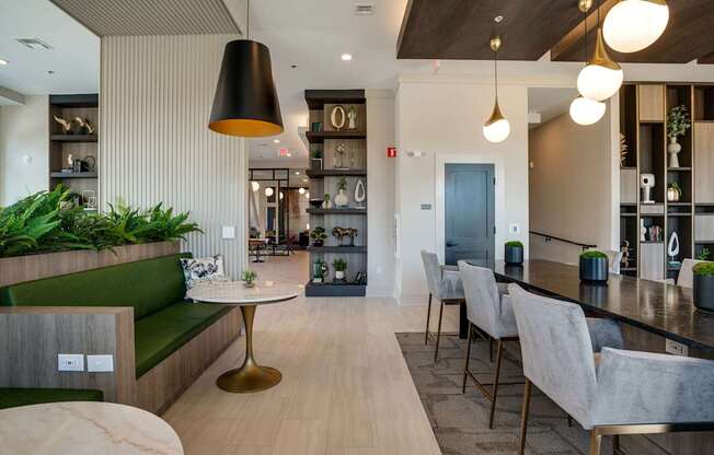 a communal area with a bar and chairs and a kitchen and dining room
