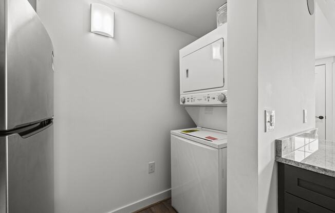 a small laundry room with a washer and dryer  at The Icon, Richmond, Virginia