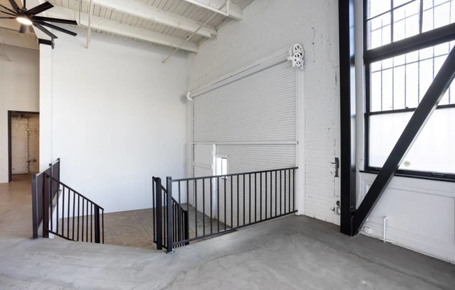 the stairway in the lobby of a building with a garage door