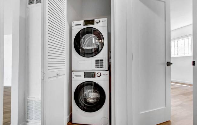 a front loading washer and dryer in a small laundry room