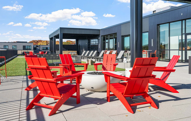 a group of red chairs outside of a building